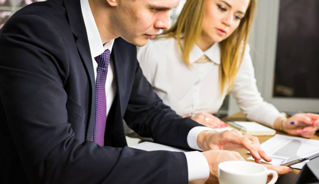 Two office workers talking in an office interior
